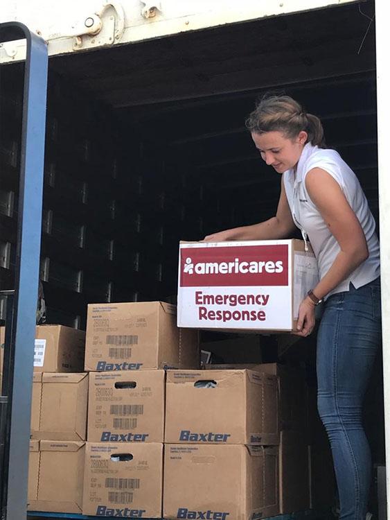 Woman unloading medical supplies from a turck
