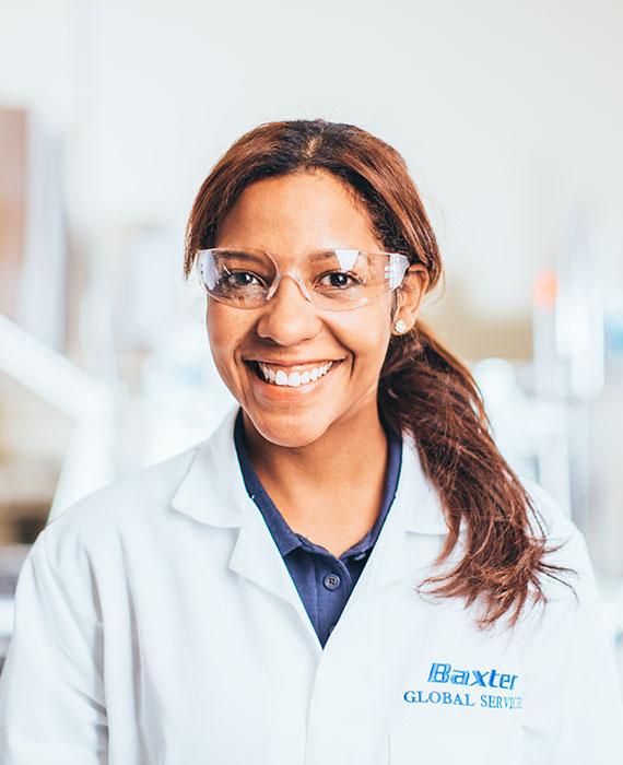 Image of Baxter female employee in a white labcoat